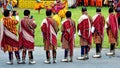 Bhutanese men in their best traditional attire witnessing a spectacular and sacred mask dance.