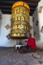 A Bhutanese old lady rotating prayer wheel , Bhutan Royalty Free Stock Photo