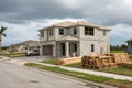 Bi-level single-family house under construction with stacks of lumber Royalty Free Stock Photo