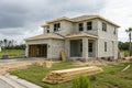 Bi-level single-family house under construction with stacks of lumber Royalty Free Stock Photo