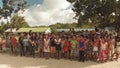 BIABAS, BOHOL, PHILIPPINES - DECEMBER 5, 2015: Children students interact with male tourists.