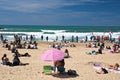 Biarritz, France - May 20, 2017: sandy beach full of people watching and taking photos of surfers isa world surfing games competit