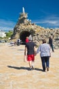 Biarritz, France - May 20, 2017: tourists visiting famous rocher de la vierge on atlantic coastline in basque country in sunny blu Royalty Free Stock Photo