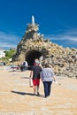 Biarritz, France - May 20, 2017: tourists visiting famous rocher de la vierge on atlantic coastline in basque country in sunny blu Royalty Free Stock Photo