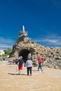 Biarritz, France - May 20, 2017: tourists visiting famous rocher de la vierge on atlantic coastline in basque country in sunny blu Royalty Free Stock Photo