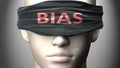 Bias can make things harder to see or makes us blind to the reality - pictured as word Bias on a blindfold to symbolize denial and