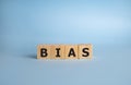 Bias - word from wooden blocks with letters, personal opinions prejudice bias concept, blue background