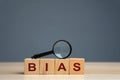 Bias word on a wooden blocks. Prejudice. Personal opinions. Preconception. Concept of facts and biases.