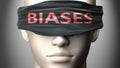 Biases can make things harder to see or makes us blind to the reality - pictured as word Biases on a blindfold to symbolize denial Royalty Free Stock Photo