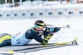 Biathlete rifle shooting lying position. Shooting range in the background