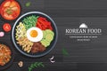 Bibimbap in the bowl on black wood table top view. Korea food background