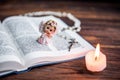 The Bible, angel and candle on wooden background. Christian faith. Christmas Day Royalty Free Stock Photo