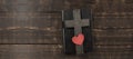 Bible book on a wooden table. Wooden cross of Jesus. Red heart. The concept of love for God`s Word. Royalty Free Stock Photo