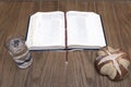 Bible, bread and water on wooden table Royalty Free Stock Photo