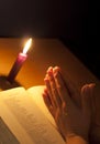 Bible candle and praying hands Royalty Free Stock Photo