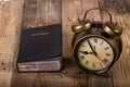 Bible with clock on wood