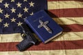 Bible cross and gun on American flag Royalty Free Stock Photo