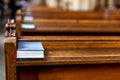 Bible on an empty pew in a church before a service Royalty Free Stock Photo