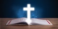 bible with glowing cross in the middle on wooden deck Royalty Free Stock Photo