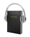 Bible and headphones on white background. Religious audiobook