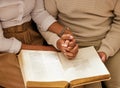 Bible, holding hands and reading with a black couple together in the home for religion, faith or belief in God. Jesus Royalty Free Stock Photo