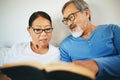 Bible, home or senior couple reading book for prayer, support or hope in bed to worship together. Education, Asian man Royalty Free Stock Photo