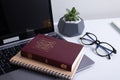 Bible and laptop on the work table with glasses. Holy Bible Study Online