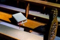 Bible lies on Kneelers in the Church Royalty Free Stock Photo