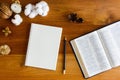 Bible with notebook, candlelight and flower over the wooden background. Royalty Free Stock Photo