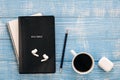 Bible, notebook, earphones and coffee cup on blue wooden background, flat lay.