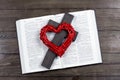 Bible open. Cross, crucifixion of Jesus. Red heart. Love concept. On a wooden table. Royalty Free Stock Photo