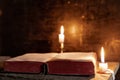 The light illuminating the bible is only from the candle. Perfect for religion, easter Royalty Free Stock Photo