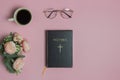 Bible with pink roses, coffee, glasses over the pink background. Royalty Free Stock Photo