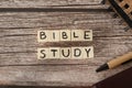 Bible study text word written on wooden cubes with holy bible, pen, and notebook on wooden table Royalty Free Stock Photo