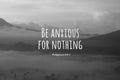 Bible verse quote - Be anxious for nothing. Philippians 4:6-7 On natural abstract art background. Misty morning in the mountain. Royalty Free Stock Photo