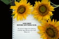 Bible verse quote - God First before anything else. Matthew 6:33 with notebook and sunflowers on black background