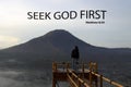 Bible verse quote - Seek God first. Matthew 6:33 With person standing on natural wooden bridge against the misty mountain.