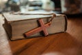 Bible with wooden cross over the wooden table. Royalty Free Stock Photo