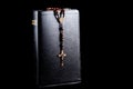 Christian Bible with Rosary and Crucifix on a Black Background Royalty Free Stock Photo