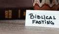 Biblical fasting concept. A close-up of handwritten text with Holy Bible Book.