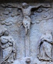 Biblical history: crucifixion of Jesus Christ, Virgin Mary and Mary Magdalene. Ancient stone statue Royalty Free Stock Photo