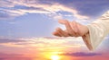 biblical scene, close-up of Jesus Christ Hand against sunset in evening beautiful dramatic sky ask for follow or following offer,