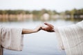 Biblical scene - of a female grabbing the hand of Jesus Christ with a blurred background Royalty Free Stock Photo