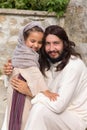 Jesus playing with a little girl Royalty Free Stock Photo