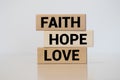 biblical, spiritual or metaphysical reminder - faith, hope and love in old wooden letterpress type blocks, stained by colorful
