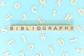 Bibliography part of a book concept. Wooden blocks typography word flat lay