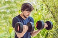 Bicep curl - weight training fitness man outside working out arms lifting dumbbells doing biceps curls. Male sports Royalty Free Stock Photo