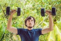 Bicep curl - weight training fitness man outside working out arms lifting dumbbells doing biceps curls. Male sports Royalty Free Stock Photo