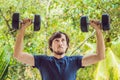 Bicep curl - weight training fitness man outside working out arms lifting dumbbells doing biceps curls. Male sports model exercisi Royalty Free Stock Photo