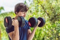 Bicep curl - weight training fitness man outside working out arms lifting dumbbells doing biceps curls. Male sports Royalty Free Stock Photo